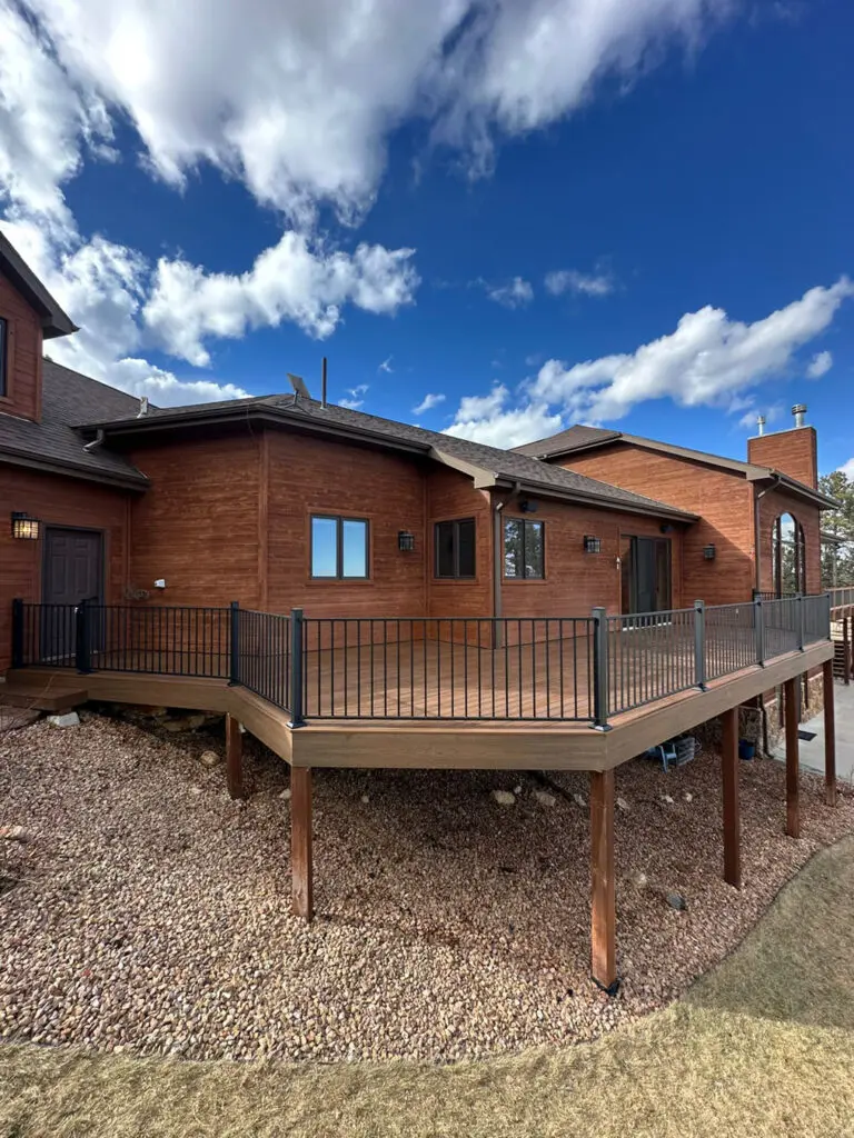 New wooden deck with iron railing and support beams